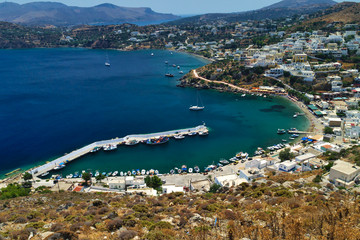 Fototapeta premium View to Panteli port in leros island. White houses contrast with blue sea. Greek island.