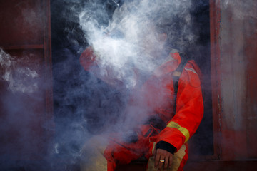 Firefighter with fire fighting equipment and accessories