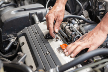 Hands of mechanic working in auto repair shop