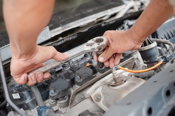 Hands of mechanic working in auto repair shop