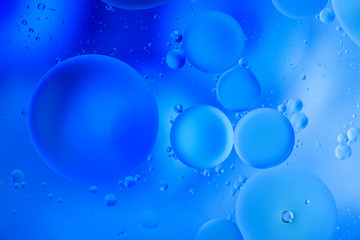 water drops on glass with blue background, close-up 