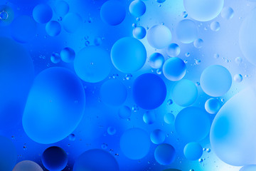 water drops on glass with blue background, close-up 