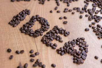 Fototapeta na wymiar Conceptional sign IDEA drawn by roasted brown coffee beans