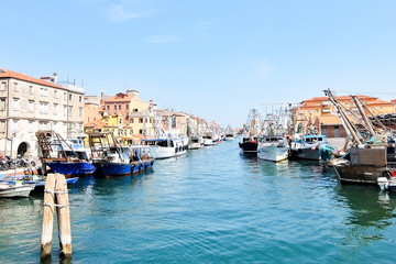 Fototapeta na wymiar Chioggia, Italy. Fishing boats moored along the city's waterfront.