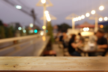 Empty dark wooden table in front of abstract blurred bokeh background of restaurant . can be used for display or montage your products.Mock up for space.