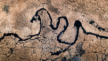 Winding river and brown swamps, aerial view