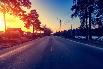 Asphalt road at sunrise and sunlight. Spring background.