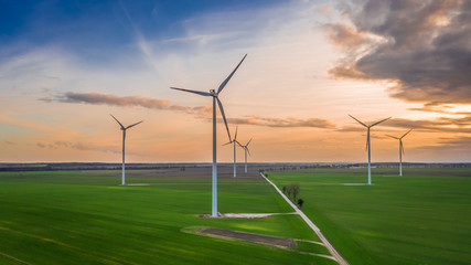 Fototapeta na wymiar Flying above stunning wind turbines at dusk