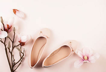 Nude colored ballerina shoes and magnolia flowers.