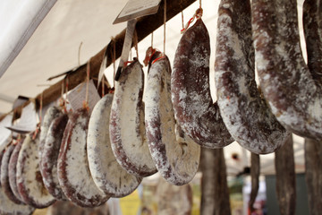 Sudzhuk or sudjuk. Flat dry salami or sausages. Gourmet meat. Delicacy salami. Flat dry sausage. 