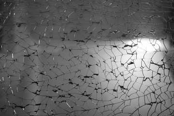 window glass or car windshield broken crack from dark anger and tempered or safety glass for interior or exterior architecture design on black white for home wall or texture background and wallpaper