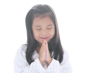 Asian child smiling hand in hand or kid girl pay obeisance and pray close eye or hello welcome and thank you with wear white shirt in morning at church or temple for peace on white background isolated