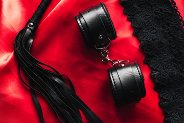 BDSM sex toys for domination and submission. Whip with handcuffs