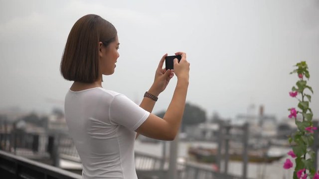Young asian woman using smartphone take photo. Beautiful asian girl tourist travel to thailand.