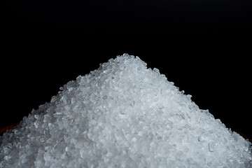 Coarse sea salt on black background