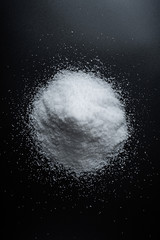 Fine salt on black background