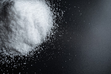 Fine salt on black background