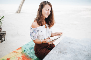 Woman is reading Tarot cards at the beach