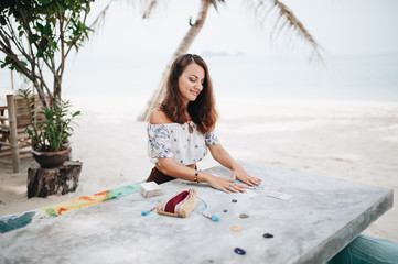 Woman is reading Tarot cards at the beach