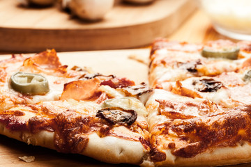 Slices of pizza with bacon, olives and jalapeno papper
