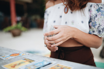 Woman is reading Tarot cards at the beach