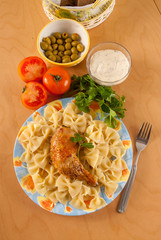pasta with fried chicken leg on a plate