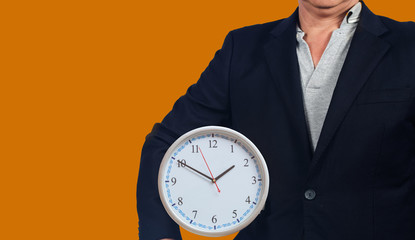 Business man hold a analog clock ,business concept.