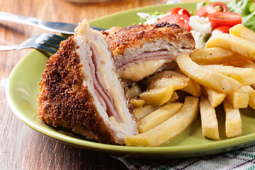 Cutlet Cordon Bleu with pork loin served with French fries and salad