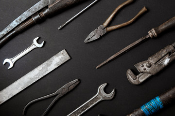 Fathers day concept. Vintage old tools on black paper background