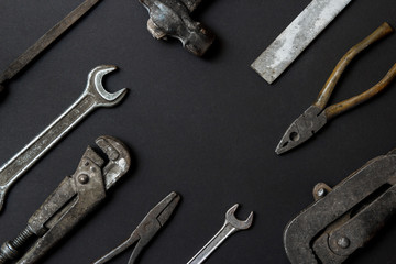 Fathers day greeting card concept. Vintage old tools on black paper background. Flat lay. Copy space