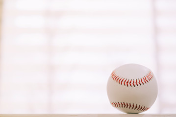 Baseball on table with window background
