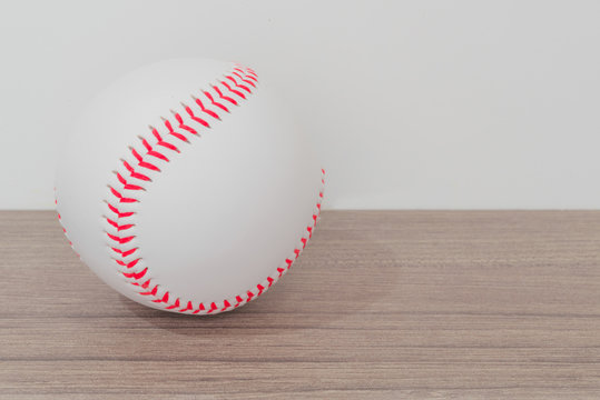 Baseball on table with white background
