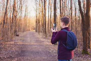 Child hiking in the woods and taking photos