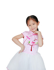 Happy little Asian child girl wearing pink Tradition Chinese dress for Chinese New Year celebration isolated on white background.