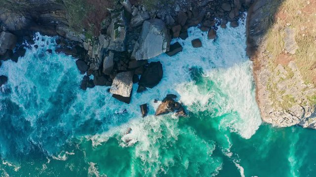 Detail of sea waves colors breaking in the coast of Lekeitio 2, Basque country - drone aerial footage - graded (ungraded version available)