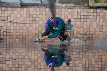 The building cleaner is climbing for clean building