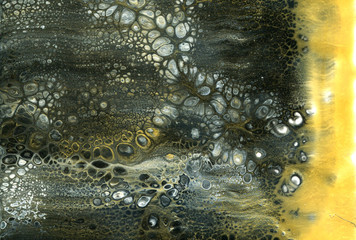 Very beautiful texture background. Black paint flows in gold with the addition of white paint. Style includes curls of marble or agate with bubbles and cells. Natural style.  Contemporary art. 