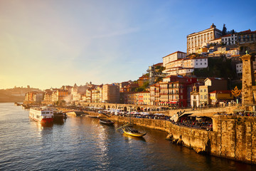 Portugal, Porto old town ribeira aerial promenade view with colorful houses, Douro river and boats.Concept of world travel, sightseeing and tourism