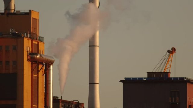 Telephoto footage of a sugar refinery expelling a toxic plume of smoke into the air