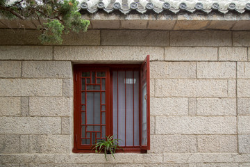 Fototapeta na wymiar red window with rock house in chinises style
