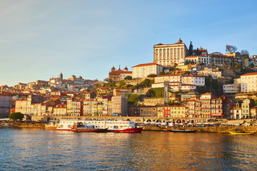 Fototapeta premium Portugal, Porto old town ribeira aerial promenade view with colorful houses, Douro river and boats.Concept of world travel, sightseeing and tourism