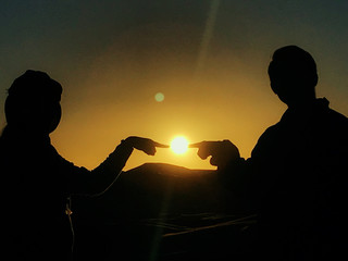 ET silhouette of couple at sunset in desert