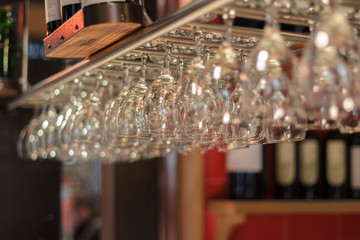Clean and clear glasses hang over the bar.