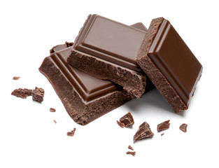 Dark organic chocolate pieces isolated on white background