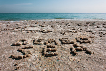 Words DEAD SEA makes from stones on the beach of real Dead sea in Israel