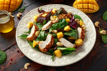 Grilled Chicken Mango salad with nuts and vegetables. Healthy food.
