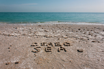 Words DEAD SEA makes from stones on the beach of real Dead sea in Israel