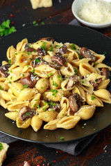 Carbonara mushrooms pasta Conchiglie with creamy sauce, parmesan cheese and herbs