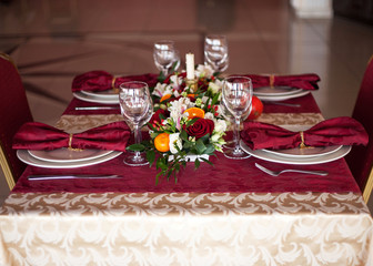 Table setting set with candles and flowers