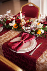 Table setting set with candles and flowers